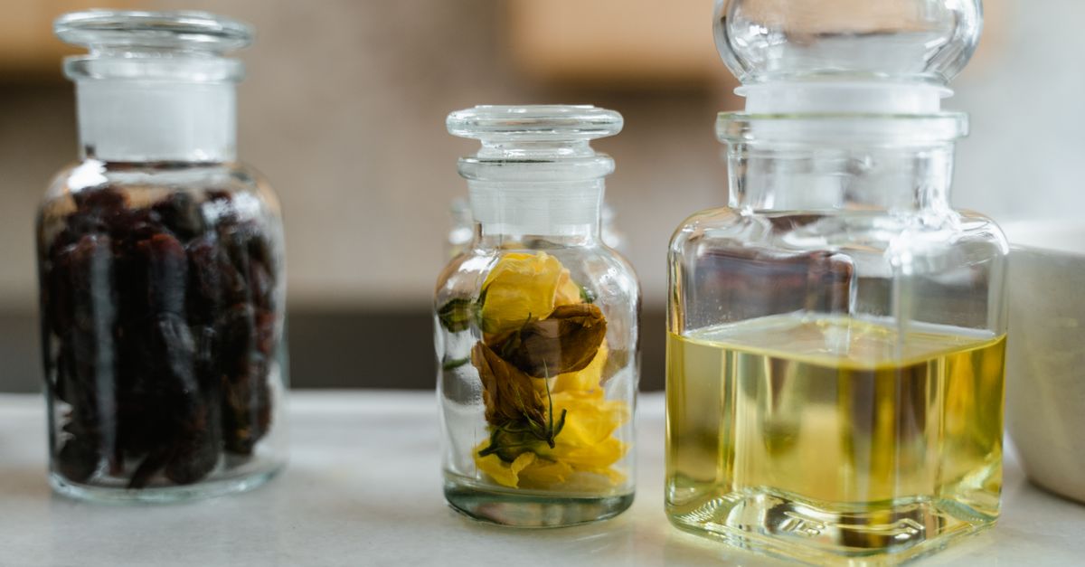 glass bottles with natural ingredients for aromatherapy on a marble surface ideal for wellness them